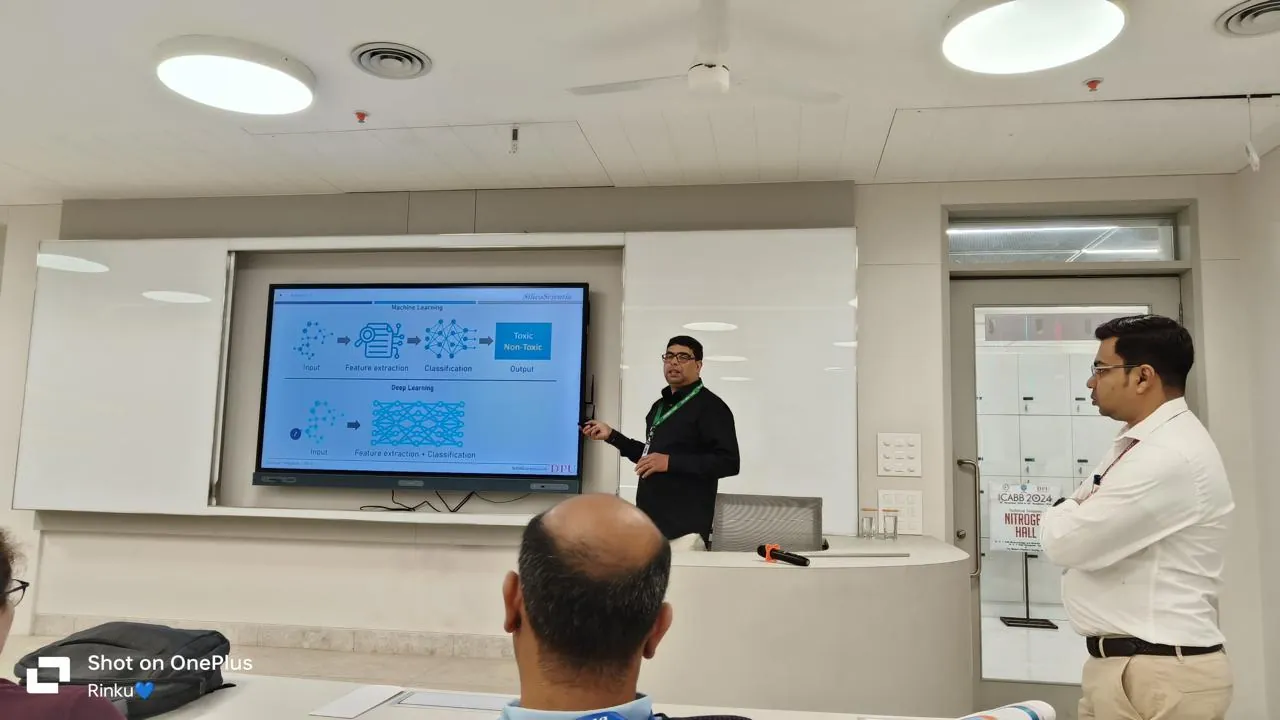 A scientist presenting a slide that compares machine learning and deep learning for toxicity prediction