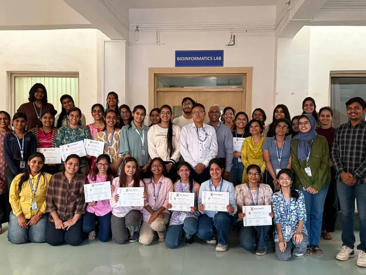 Participants holding their certificates outside the Bioinformatics Lab at Bharati Vidyapeeth, Pune